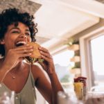 woman eating in restaurant in summer