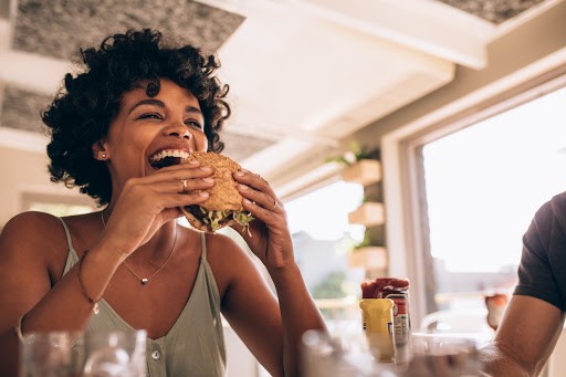 woman eating in restaurant in summer