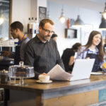 man in restautant tracking utility bills