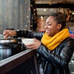 happy woman serving herself soup